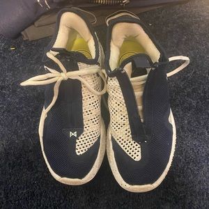 PG 4 Navy & White basketball shoes wore inside a gym  size 4.5